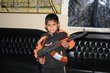 A boy carries his police officer father's AK-47 in Fallujah, January 2007.